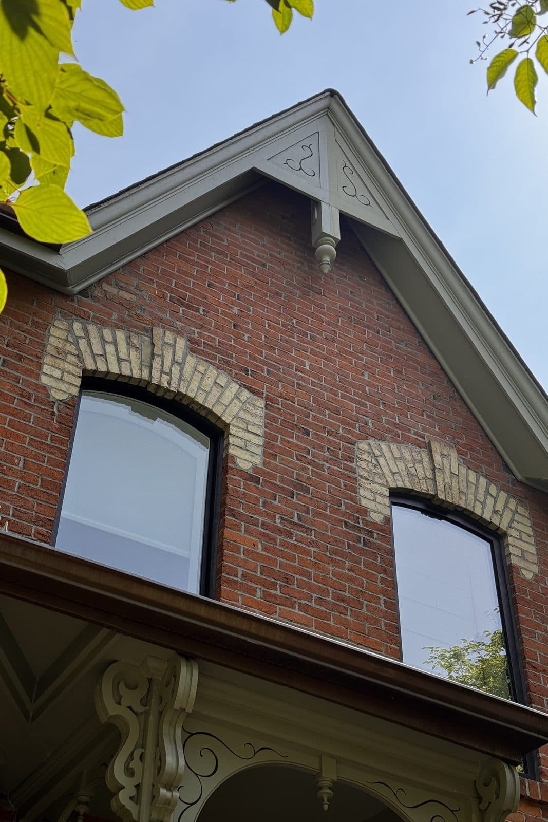 Red brick gable with arched brick voussoirs and cream bargeboard trim