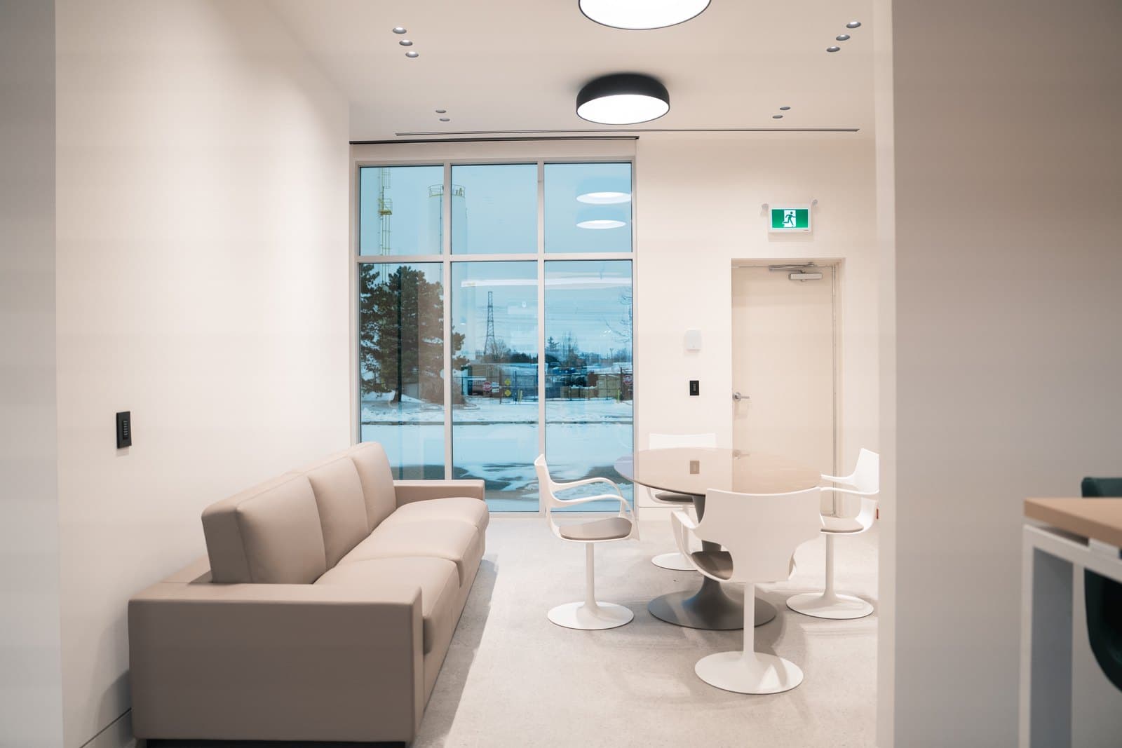 Reception lounge with floor to ceiling glazing and a soft seating arrangement