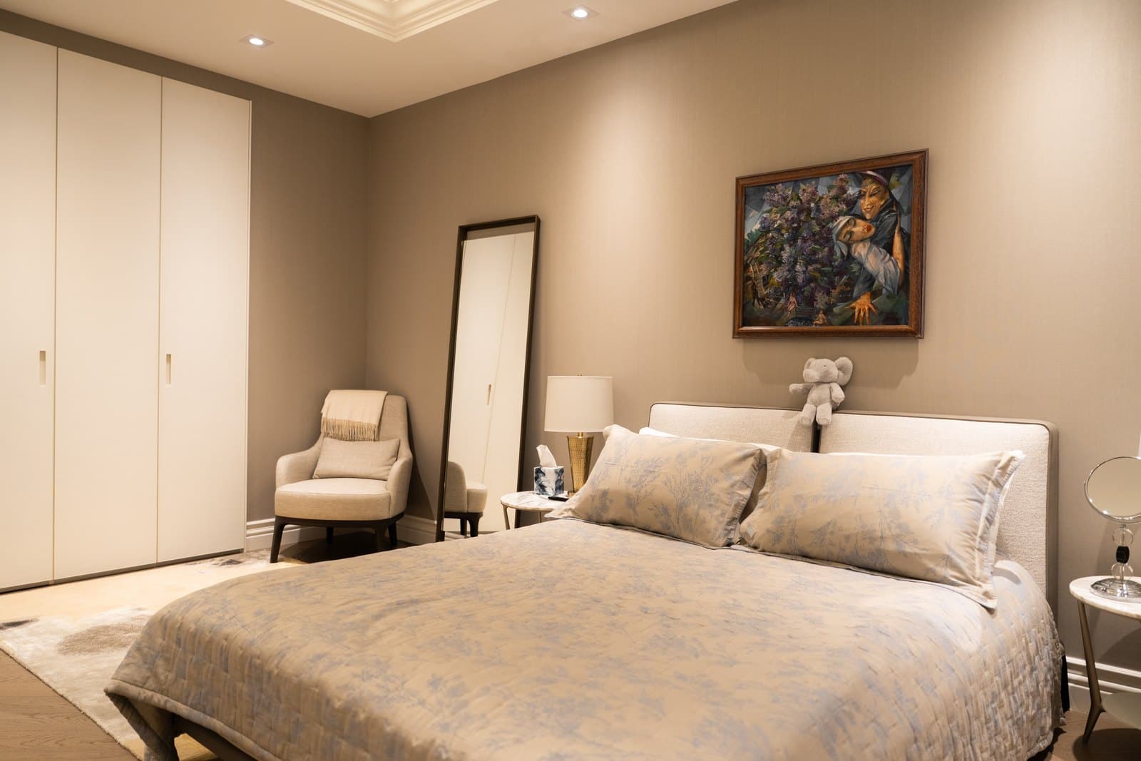 Bedroom with an upholstered bed and fitted wardrobes
