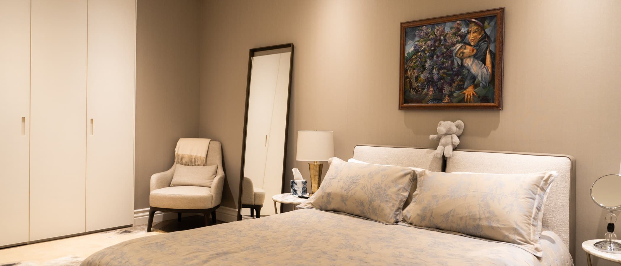 Bedroom with an upholstered bed and fitted wardrobes