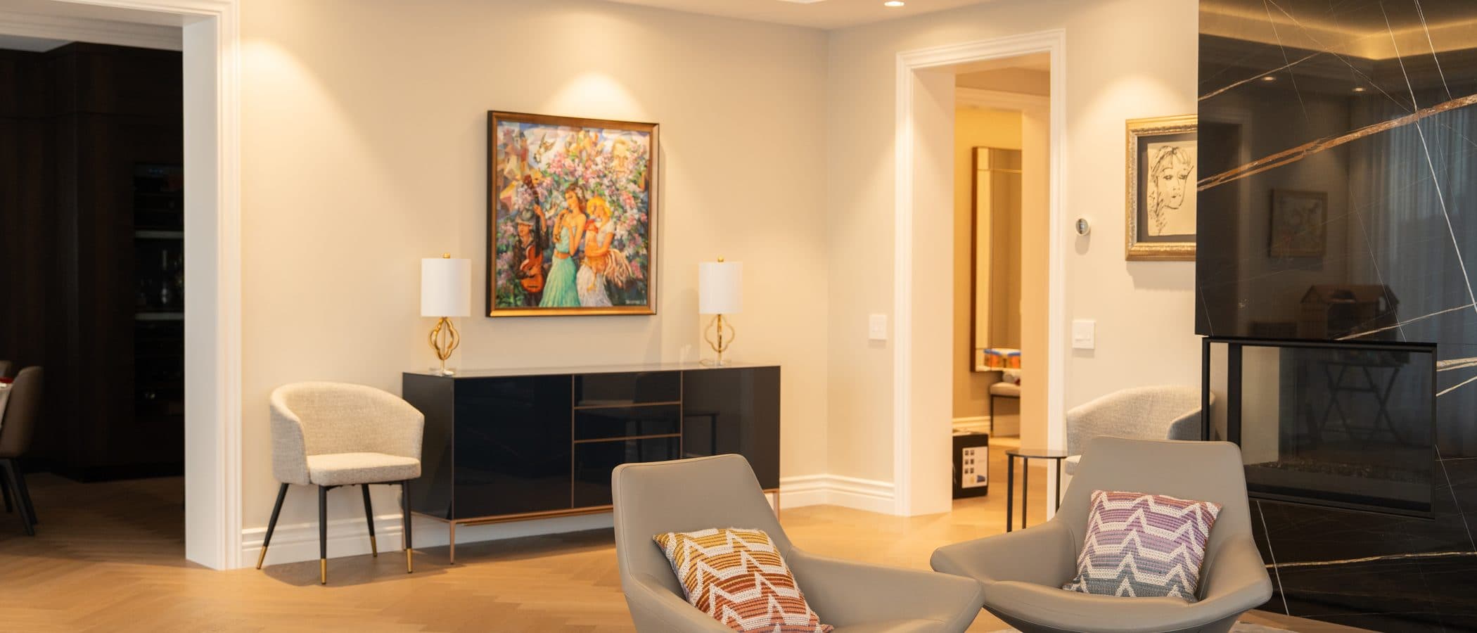 Figurative painting above a black lacquer console with brass trim