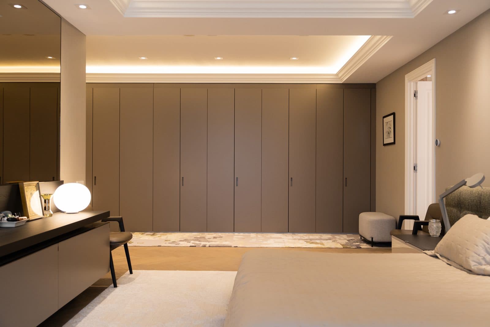Bedroom wardrobe wall in flush taupe cabinetry