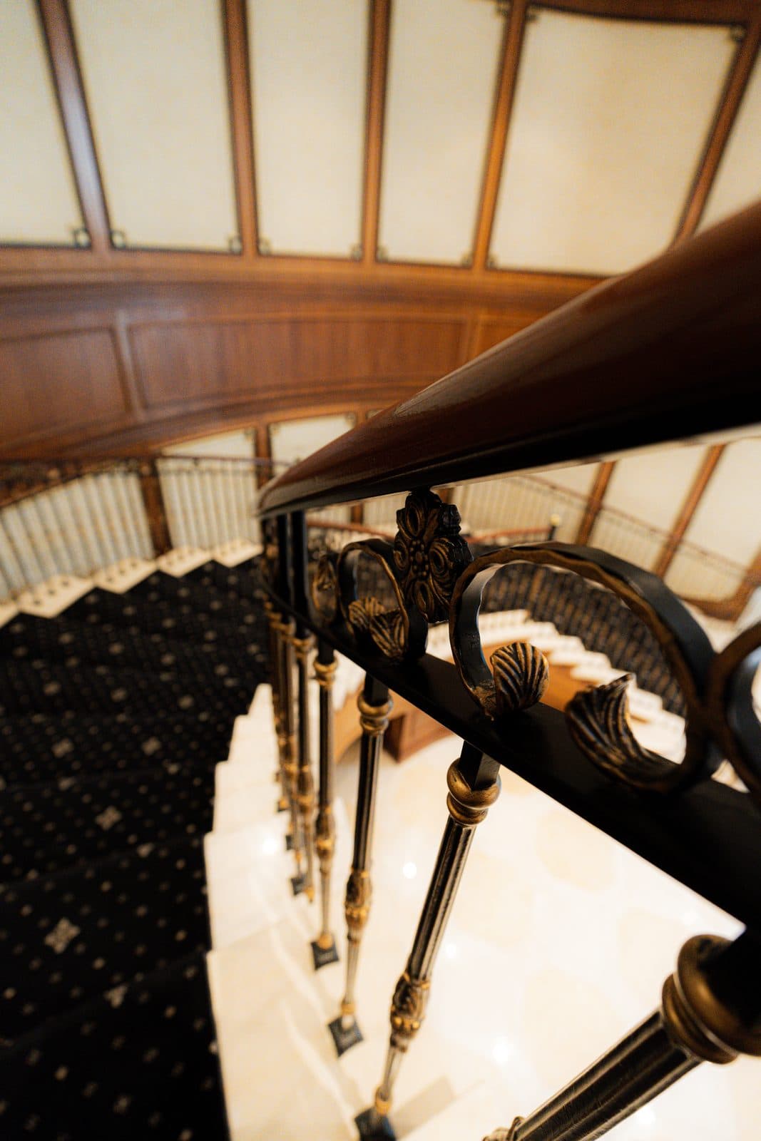 Wrought iron handrail scrollwork with gilt ornament